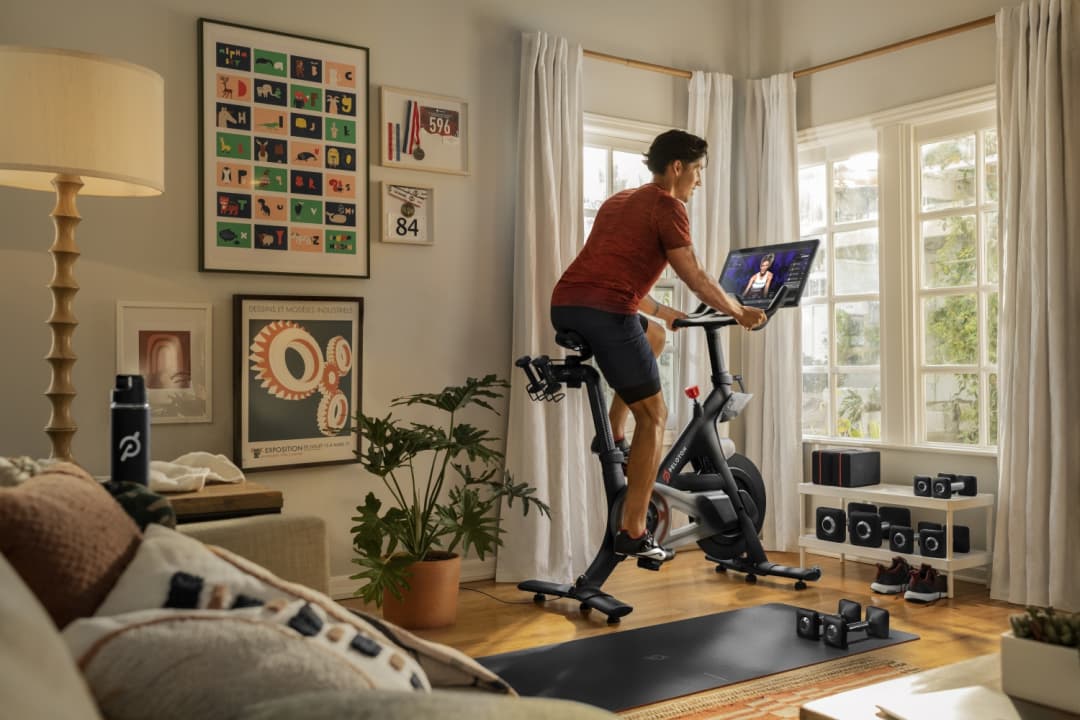 A photograph of a man cycling on a Peloton.